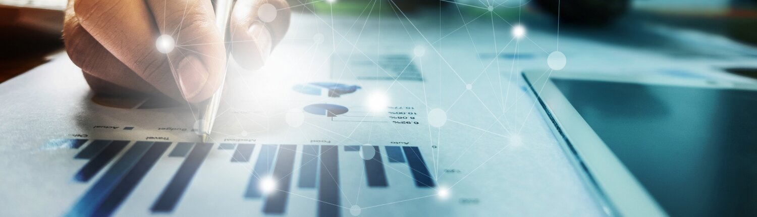Close up Businessman hand holding pen and pointing at financial paperwork with financial network diagram.